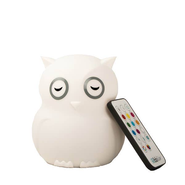 White owl-shaped night light with a remote control on a white background