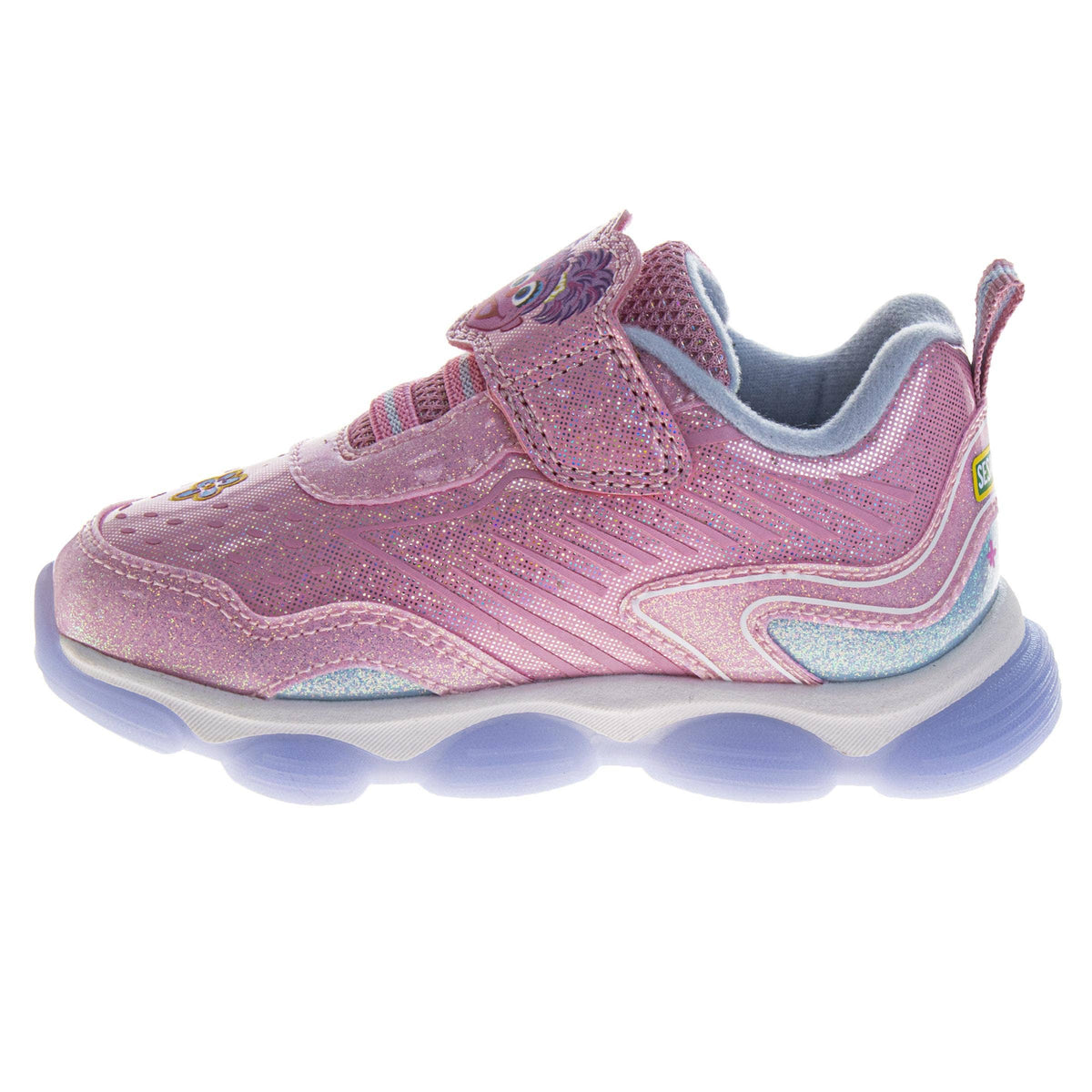 Pink children's shoe with blue sole on a white background