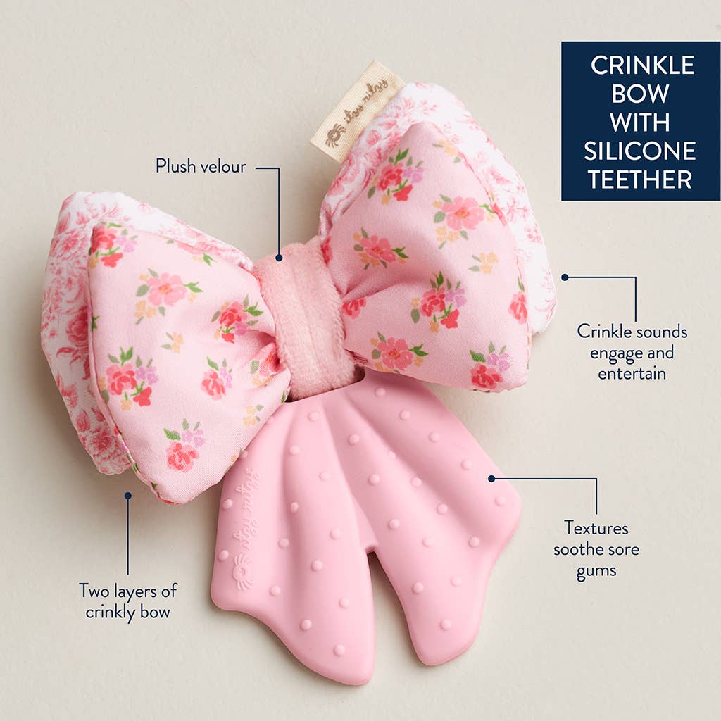 Pink crinkle bow with silicone teether on a light background